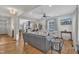 Open living room featuring hardwood floors, gray sectional sofa, and built-in shelving at 810 Brooklyn St, Raleigh, NC 27605