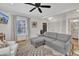 Spacious living room with hardwood floors, gray sectional sofa and white armchair at 810 Brooklyn St, Raleigh, NC 27605
