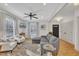 Living room with hardwood floors, gray sectional sofa, and two armchairs at 810 Brooklyn St, Raleigh, NC 27605