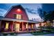 Exterior view of a red barn-style clubhouse at sunset at 97 Windchime Ct, Fuquay Varina, NC 27526