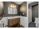 Modern bathroom with dark wallpaper and wood vanity at 100 Kingsbury Dr # 100, Chapel Hill, NC 27514