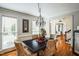 Charming dining room with a dark wood table and elegant chandelier at 1317 Woodmanor Dr, Raleigh, NC 27614