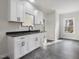 Basement bar with white cabinets and dark countertops at 191 Pine Lake Dr, Siler City, NC 27344