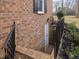 Walkout basement with brick exterior and wrought iron railing at 191 Pine Lake Dr, Siler City, NC 27344