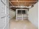 Unfinished basement with shelving and window at 191 Pine Lake Dr, Siler City, NC 27344