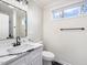 Modern bathroom with black and white tile, marble vanity, and new fixtures at 191 Pine Lake Dr, Siler City, NC 27344