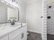 Modern bathroom with white subway tile and a marble countertop at 191 Pine Lake Dr, Siler City, NC 27344