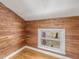 Unique bedroom with wood walls and a window overlooking trees at 191 Pine Lake Dr, Siler City, NC 27344