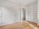 Well-lit bedroom with hardwood floors, built-in shelving, and closet at 191 Pine Lake Dr, Siler City, NC 27344