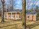 Brick house with columns, large windows, and a spacious lawn at 191 Pine Lake Dr, Siler City, NC 27344