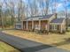 Ranch style brick house with a long driveway and landscaping at 191 Pine Lake Dr, Siler City, NC 27344