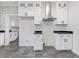 Modern kitchen with white cabinets, stainless steel appliances, and dark countertops at 191 Pine Lake Dr, Siler City, NC 27344