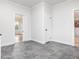 Transitional kitchen area with grey tile floor and pocket door at 191 Pine Lake Dr, Siler City, NC 27344