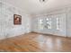 Spacious living area with hardwood floors and white brick accent wall at 191 Pine Lake Dr, Siler City, NC 27344
