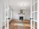 Spacious living room with hardwood floors, fireplace and French doors at 191 Pine Lake Dr, Siler City, NC 27344