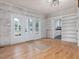 Bright living room with white brick wall and hardwood floors at 191 Pine Lake Dr, Siler City, NC 27344