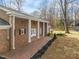 Brick porch with columns, providing a relaxing outdoor space at 191 Pine Lake Dr, Siler City, NC 27344