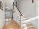 Elegant curved staircase with wooden banister and hardwood floors at 191 Pine Lake Dr, Siler City, NC 27344