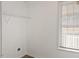 Laundry area with overhead shelving and exterior window at 204 Barbour Rd, Smithfield, NC 27577