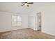 Spacious main bedroom with vaulted ceiling, carpet, and large window at 204 Barbour Rd, Smithfield, NC 27577
