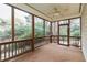 Relaxing screened porch with wood flooring and ceiling fan at 422 Wayfield Ln, Cary, NC 27518