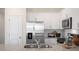 Modern kitchen with stainless steel appliances and granite countertops at 454 Belgian Red Way, Wake Forest, NC 27587