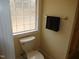 Bathroom with toilet and a block window for light at 513 Port Dr, Henderson, NC 27537
