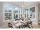 Elegant dining area with large windows and a modern light fixture at 684 Golfers Vw, Pittsboro, NC 27312