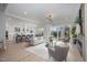Open living room features hardwood floors, fireplace, and access to backyard patio at 684 Golfers Vw, Pittsboro, NC 27312
