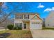 Two-story house with beige vinyl siding, a white garage door, and a well-maintained lawn at 722 Blue Lake Dr, Mebane, NC 27302