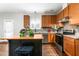 Eat-in kitchen with wood cabinets, stainless steel appliances, and an island at 722 Blue Lake Dr, Mebane, NC 27302