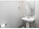 Clean and modern powder room with pedestal sink and stylish mirror at 722 Blue Lake Dr, Mebane, NC 27302