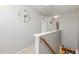 Upstairs hallway with unique clock and access to bedrooms at 722 Blue Lake Dr, Mebane, NC 27302