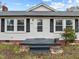 Front view of a white house with black shutters and a small porch at 826 Carter Ave, Durham, NC 27703