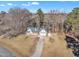Brick house with attached garage, viewed from above; nestled amongst tall trees at 101 Creekside Dr, Selma, NC 27576