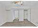 Light-filled bedroom with laminate floors, double closets, and ceiling fan at 101 Creekside Dr, Selma, NC 27576
