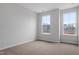 Spacious bedroom with two large windows and neutral walls at 1042 Westerland Way # 213, Durham, NC 27703