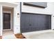 Attached garage with a black sectional door and exterior lighting at 1042 Westerland Way # 213, Durham, NC 27703