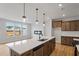 Modern kitchen with an island, stainless steel appliances, and hardwood floors at 1042 Westerland Way # 213, Durham, NC 27703