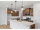 Modern kitchen featuring hardwood floors, an island with quartz countertops, and stainless steel appliances at 1042 Westerland Way # 213, Durham, NC 27703