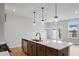 Open concept kitchen with an island, stainless steel appliances, and pendant lighting at 1042 Westerland Way # 213, Durham, NC 27703