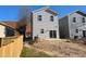 Two-story house rear elevation showing a wooden fence and patio at 110-A S Hyde Park Ave, Durham, NC 27703