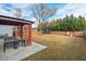 Spacious backyard with grassy area, wooden fence, and play equipment at 125 Windrush Ln, Durham, NC 27703