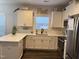 Modern kitchen featuring white cabinets, stainless steel appliances, and an L-shaped island at 1406 Summerville Mamers Rd, Lillington, NC 27546