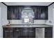 Modern kitchen with granite countertops and dark wood cabinets at 301 E Lewis St, Four Oaks, NC 27524