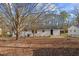 Back of house with mature trees and yard at 409 Avery Street St, Garner, NC 27529