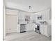 Modern kitchen with white shaker cabinets, stainless steel appliances, and quartz countertops at 409 Avery Street St, Garner, NC 27529