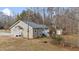 Rear view of a house with a deck, shed, and wooded backyard at 5584 Wingate Creek Rd, Oxford, NC 27565