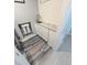 Laundry room with white cabinets, a utility sink, and stylish tile flooring at 5705 Katha Dr, Holly Springs, NC 27540