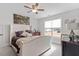 Bedroom with large window, comfortable bed, and ceiling fan at 68 Jeans Way, Benson, NC 27504